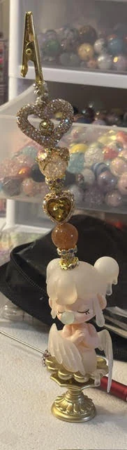 Handmade decorative charm with hearts, rhinestones and a doll figure